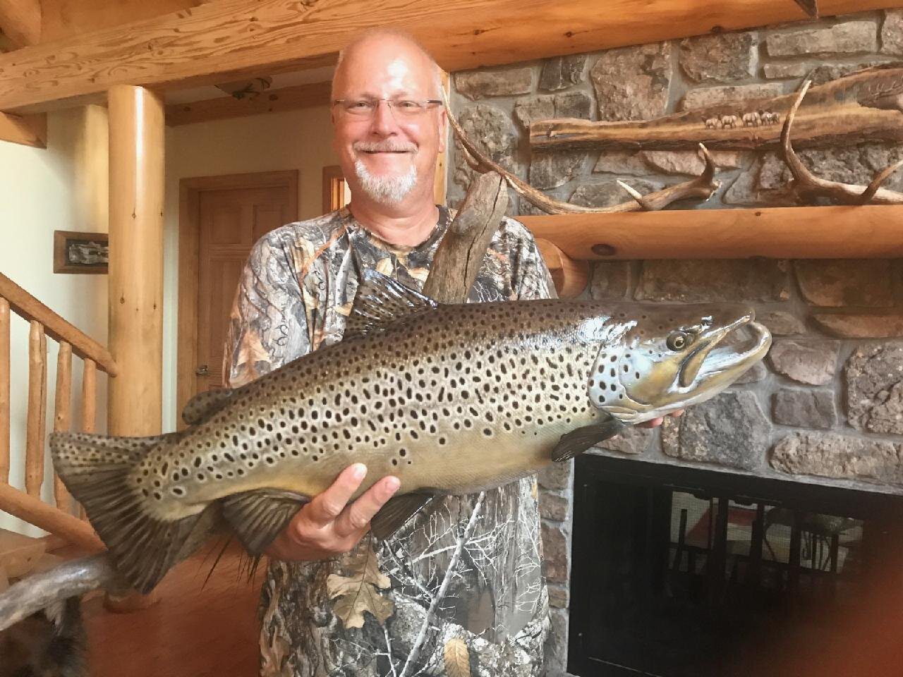 A man holding a large fish in his hands.